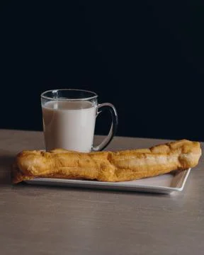 Tea Time Special milk with bread served in a dish isolated on dark background Stock Photos