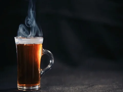 Tea in transparent Cup on a dark background. Slow motion Stock Footage 73671977