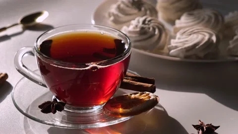 Tea in a transparent mug or cup on a white, light background with marshmallow or Stock Footage 197526670