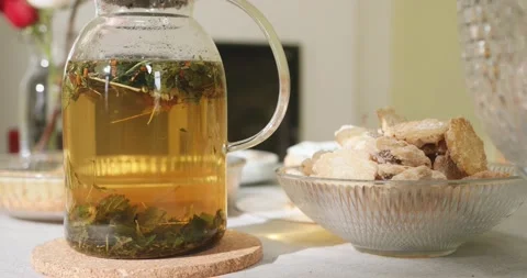Tea in a transparent teapot on the table with cookies on a plate. Herbal tea. 스톡 동영상 151949193