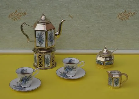 Tea for two, teacups, silver-plated teapot, cream jug, sugar bowl Stock Photos