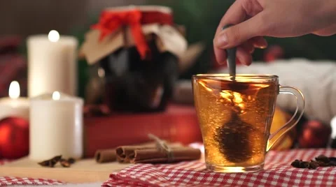 Tea in a white mug with a spoon stir the sugar Christmas with slow motion Stock Footage 56557284