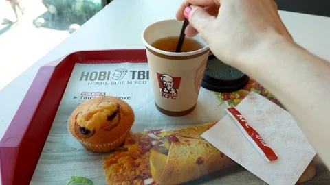 Tea whith muffin in  KFC cafe. Kyiv, Ukraine- july 5, 2019 Stock Footage 114267326