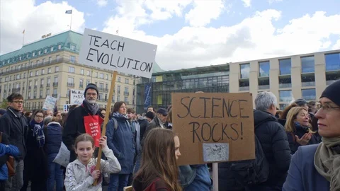 Teach evolution, Science rocks, children hold signs, march protest demo, Berlin Stock Footage