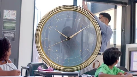 Teacher addressing class, clock marking time, students raising hands, using Stock Footage 337905043