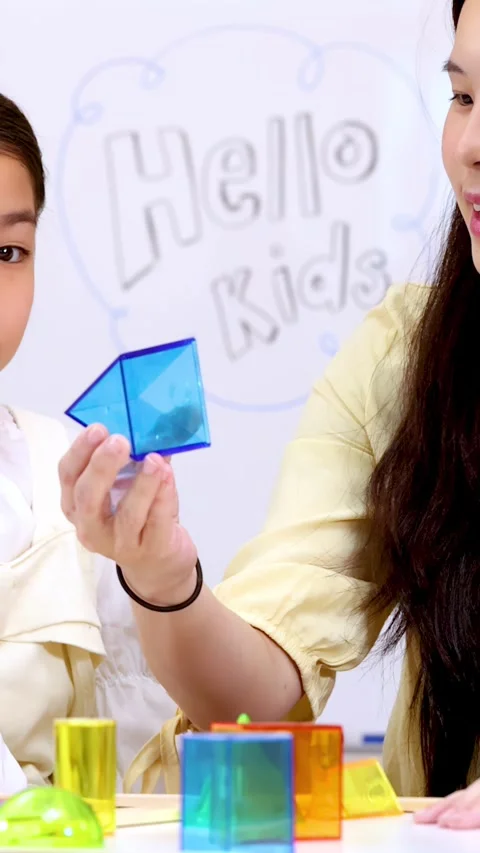 Teacher and Child Learning Geometry with Colorful Blocks Stock Footage 329215869