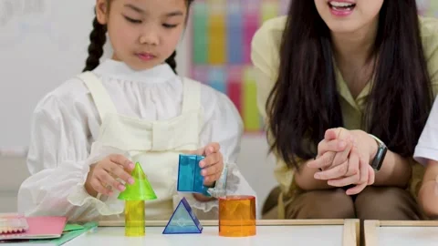 Teacher and Primary Student Learning Geometry with 3D Shapes in Classroom Vídeos de archivo 329216051