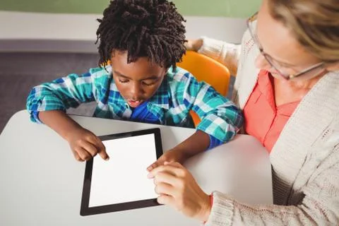 Teacher and pupil using a tablet Stock Photos