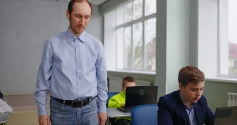 Teacher And Pupils In Programming And Coding Courses For Children In Classroom Stock Footage 280173888