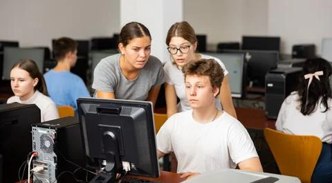 Teacher and pupils studying computer science Stock Photos