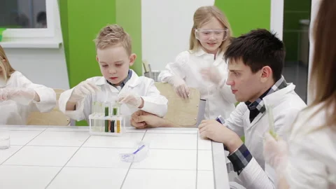 Teacher and schoolboy make experiments in the chemistry class Stock Footage 86556348
