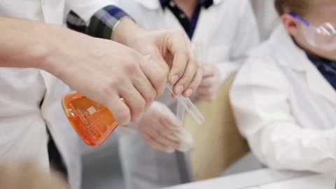 Teacher and schoolboy make experiments in the chemistry class Stock Footage 87162399