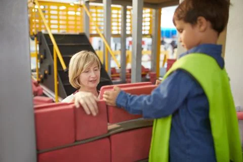 Teacher and schoolboy stacking bricks at interactive construction exhibit in Stockfoto's