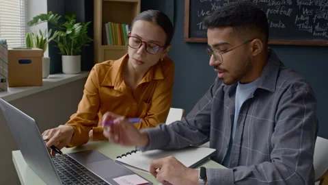 Teacher and Student Discussing Work on Laptop Stock Footage 314837892