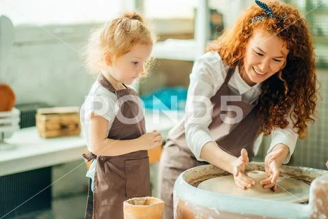 Teacher and student make pitcher of pottery wheel Stock Photos