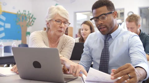 Teacher and student using laptop at an adult education class Stock Footage
