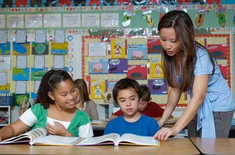 Teacher And Students In Classroom Stock Photos