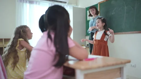 Teacher and students, Learn and study in a classroom of school Stock Footage 283062011