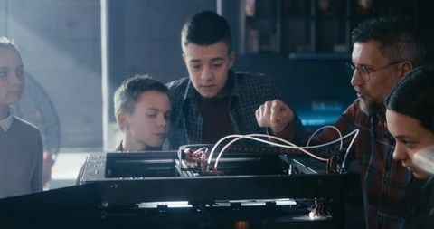 Teacher and students using 3D printer Stock Footage 127496071