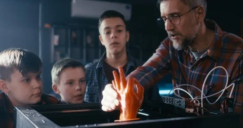 Teacher and students using 3D printer Stock Footage 127500339