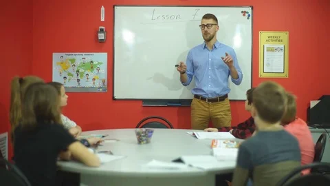 The teacher asks a group of students Stock Footage 70578352