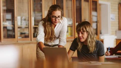 Teacher assisting the problem of a student Stock Photos