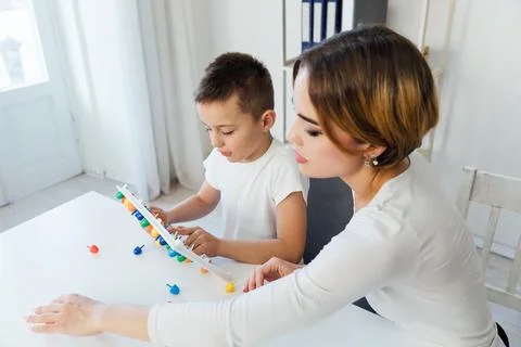 Teacher with boy in school training development Foto stock