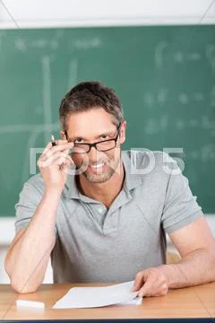 Teacher checking examination papers Stock Photos
