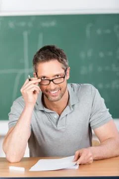 Teacher checking examination papers Stock Photos