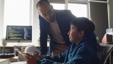 Teacher Checking on Indian Boy Working on Tablet at Coding Class Video stock 278126771