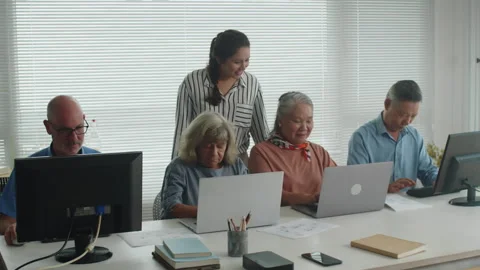 Teacher Checking Senior Students Progress on Computer Class Stock Footage 263699043