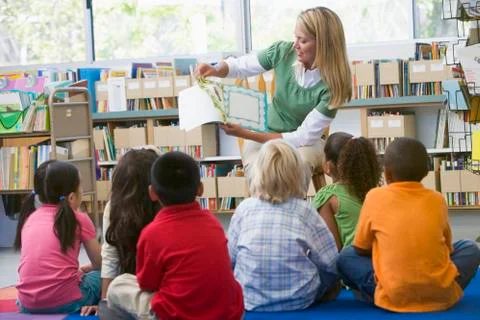 Teacher in class reading to students Stock Photos