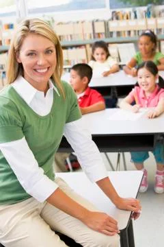 Teacher in class with students in background (selective focus) Stock Photos