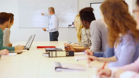 Teacher in classroom giving math presentation Stock Footage 32818002