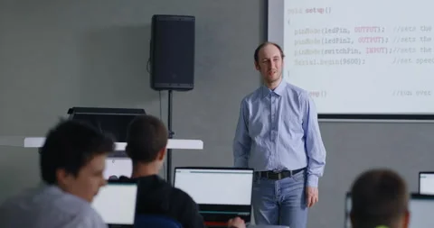 Teacher Of Computer Science And Programming Speaking In Classroom, Pupils Stock Footage 281613971