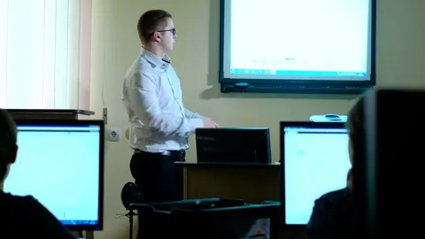 Teacher with computer takes a math class 4k Vídeos de archivo 74585060
