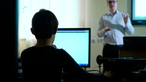 Teacher with computer takes a math class 4k Stock Footage 74585106