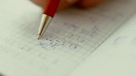 Teacher corrects in notebook with ballpoint pen Stock Footage 261869281