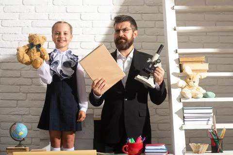 Teacher dad working with creative child girl. Kids education, elementary school Stock Photos