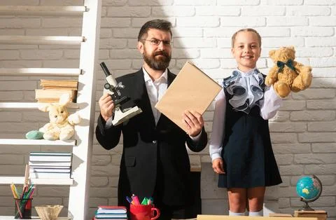 Teacher dad working with creative child girl. Kids education, elementary school Stock Photos
