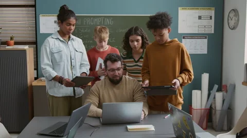Teacher Demonstrating to Diverse Students How to Work with AI Generator Stock Footage 318721816