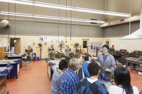 Teacher demonstrating to machine shop class Stock Photos