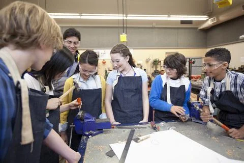 Teacher demonstrating in machine shop class Stock Photos