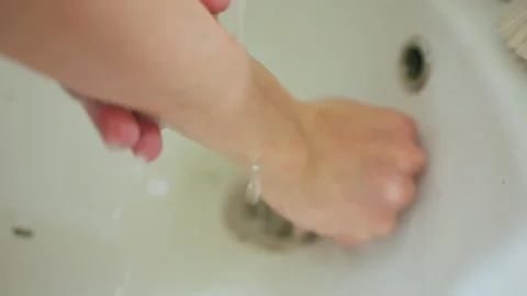 Teacher demonstrating proper hand cleaning techniques in studio environment. Art Stock Footage 342283094