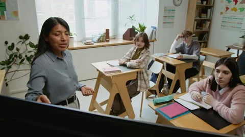 Teacher Demonstrating Visual Aids on Digital Screen to Students at Lesson Stock Footage 333736276