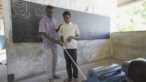 Teacher of disabilities working with blind students in school classroom. Video stock 121456328