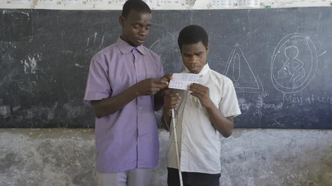 Teacher of disabilities working with blind students in school classroom. Video stock 121456602