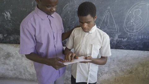 Teacher of disabilities working with blind students in school classroom. Stock Footage 121457612