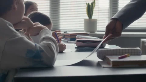 Teacher Distributing Assignment during Classroom Lesson Vídeo Stock 311543878