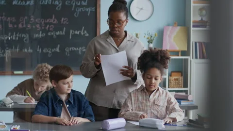 Teacher Distributing Worksheets to Attentive Students in Class Vídeo Stock 312055799